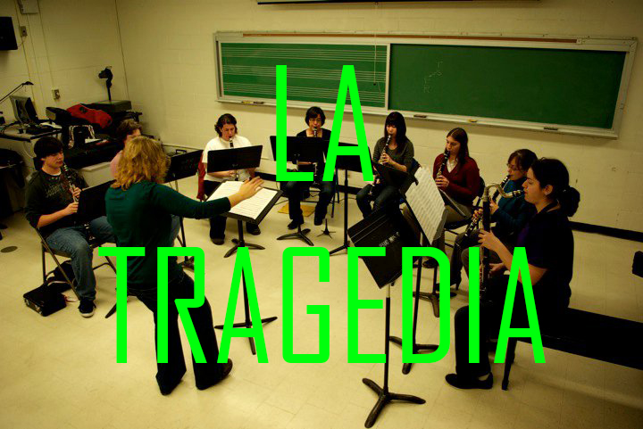A photograph from a high angle of 8 clarinetists and a conductor rehearsing in a classroom. Click the photograph to listen to La Tragedia.